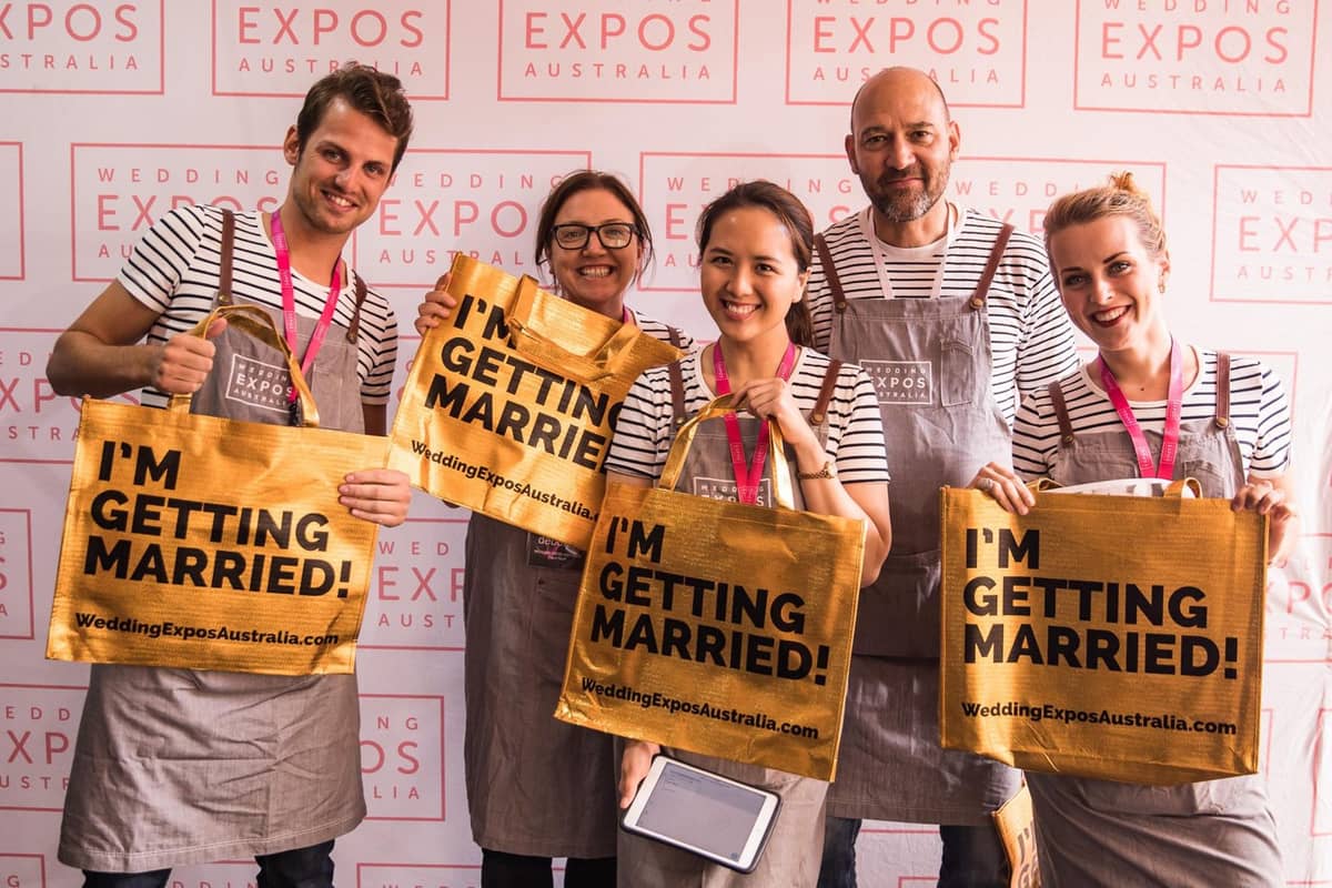 Wedding Expos Australia event team holding gold I’m Getting Married bags