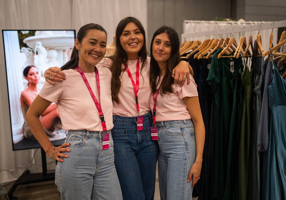 Three Wedding Expos Australia exhibitors smiling together at an expo